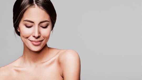 Portrait of a beautiful young woman with perfect fresh clean skin.